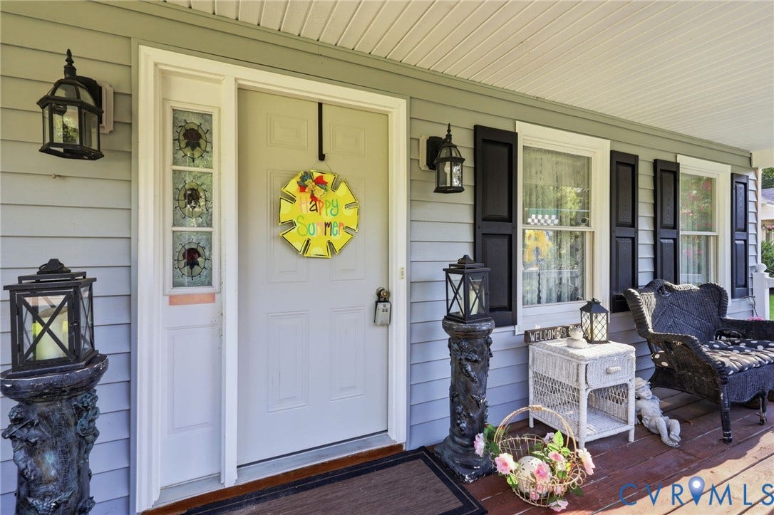 3819 Glen Oaks Court, Chester, VA 23831 Covered front porch featuring light gray siding with white trim, a white entry door with decorative sidelights,