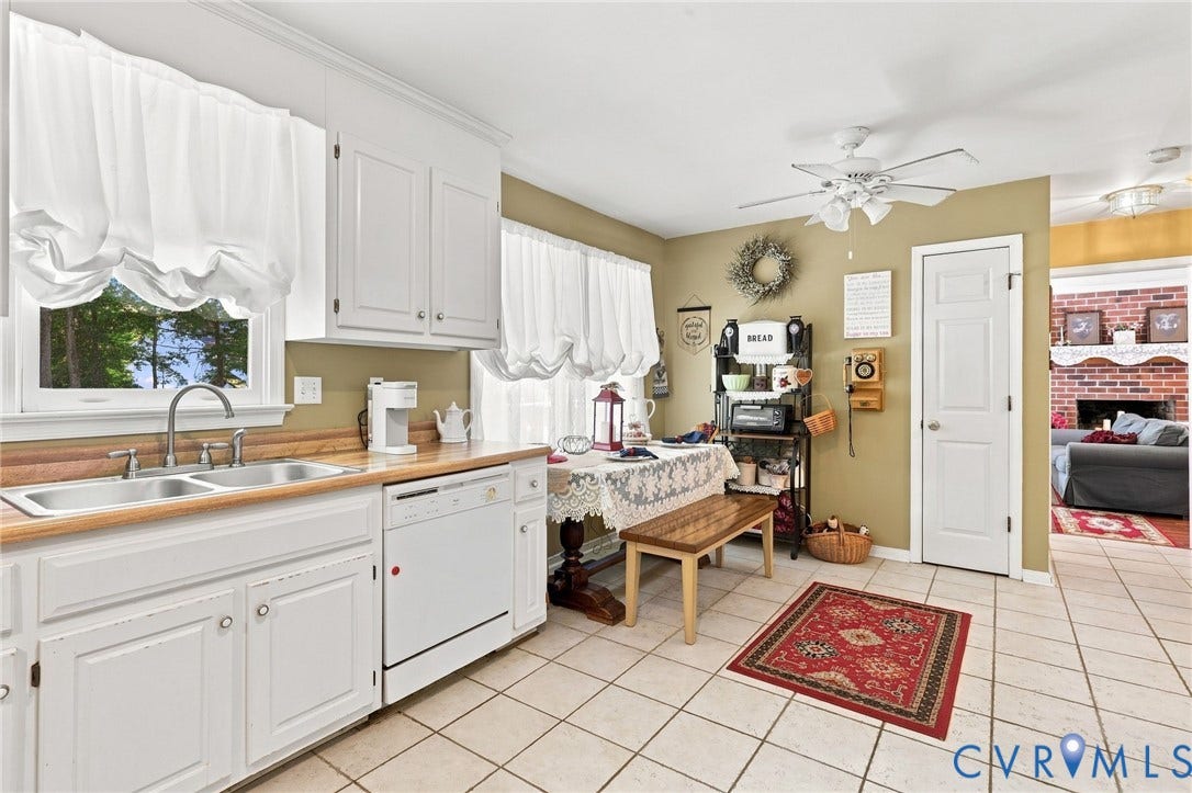 3819 Glen Oaks Court, Chester, VA 23831 Kitchen featuring white cabinetry, light wood-finish countertops, and a dual-basin stainless steel sink with a gooseneck faucet