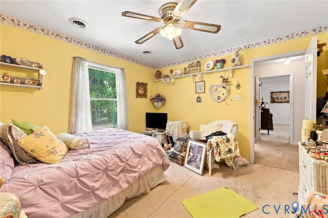 3819 Glen Oaks Court, Chester, VA 23831 Carpeted interior space featuring a window with exterior visibility, a ceiling fan, and wall-mounted shelving