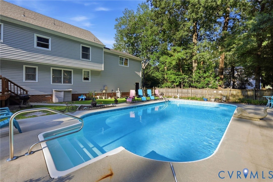 3819 Glen Oaks Court, Chester, VA 23831 Outdoor swimming pool with concrete surround, integrated steps, and stainless steel handrail