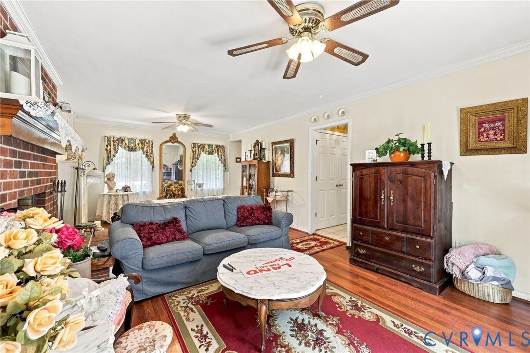 3819 Glen Oaks Court, Chester, VA 23831 Spacious living area featuring hardwood flooring, a brick fireplace, and crown molding