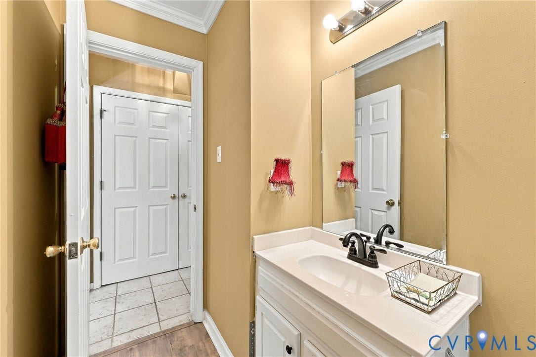 3819 Glen Oaks Court, Chester, VA 23831 Bathroom vanity featuring a white countertop with an integrated sink, dark-finish faucet, and an overhead vanity light