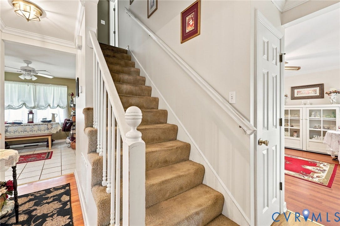 3819 Glen Oaks Court, Chester, VA 23831 Carpeted staircase with white balusters and a decorative newel post