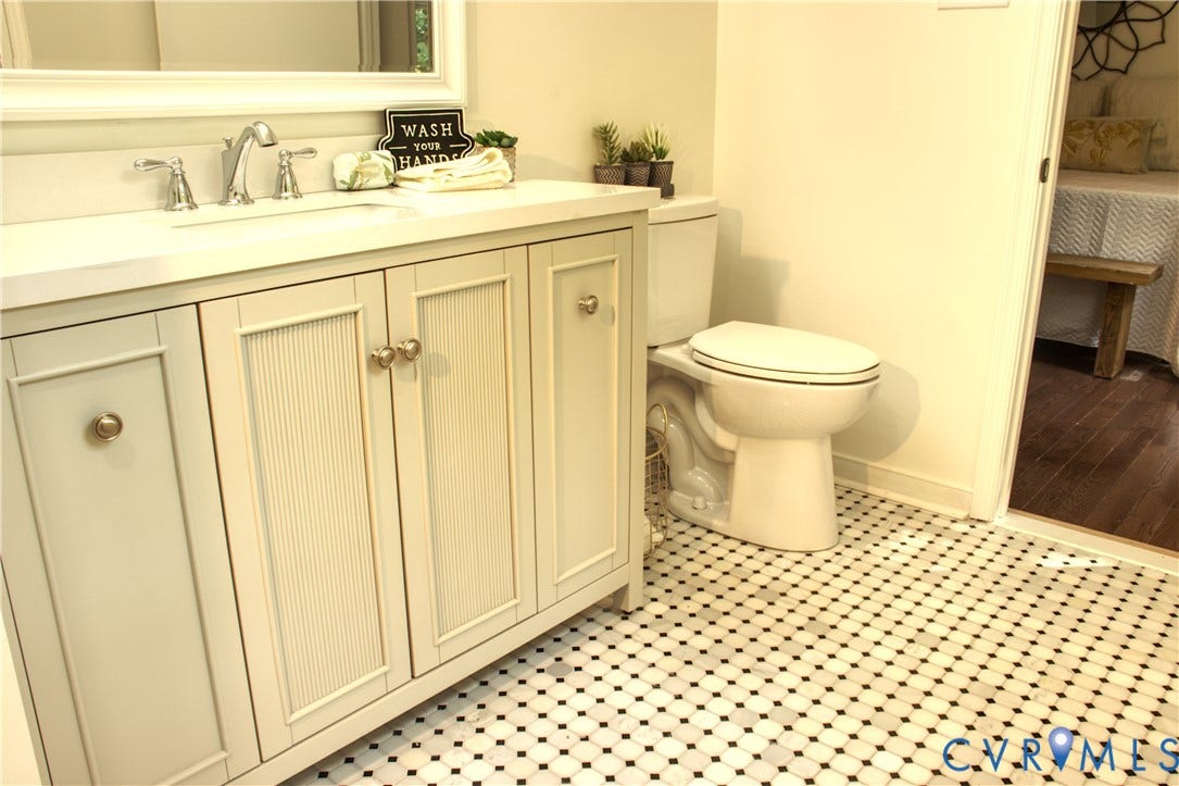 5004 Fairlake Lane, Henrico, VA 23060 Bathroom featuring a vanity with shaker-style and reeded cabinet doors, a white countertop, and a classic black and white mosaic tile floor