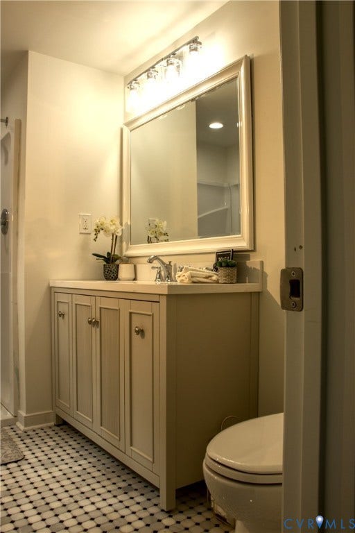 5004 Fairlake Lane, Henrico, VA 23060 Contemporary bathroom vanity featuring a light-toned cabinet, integrated sink, and coordinating countertop