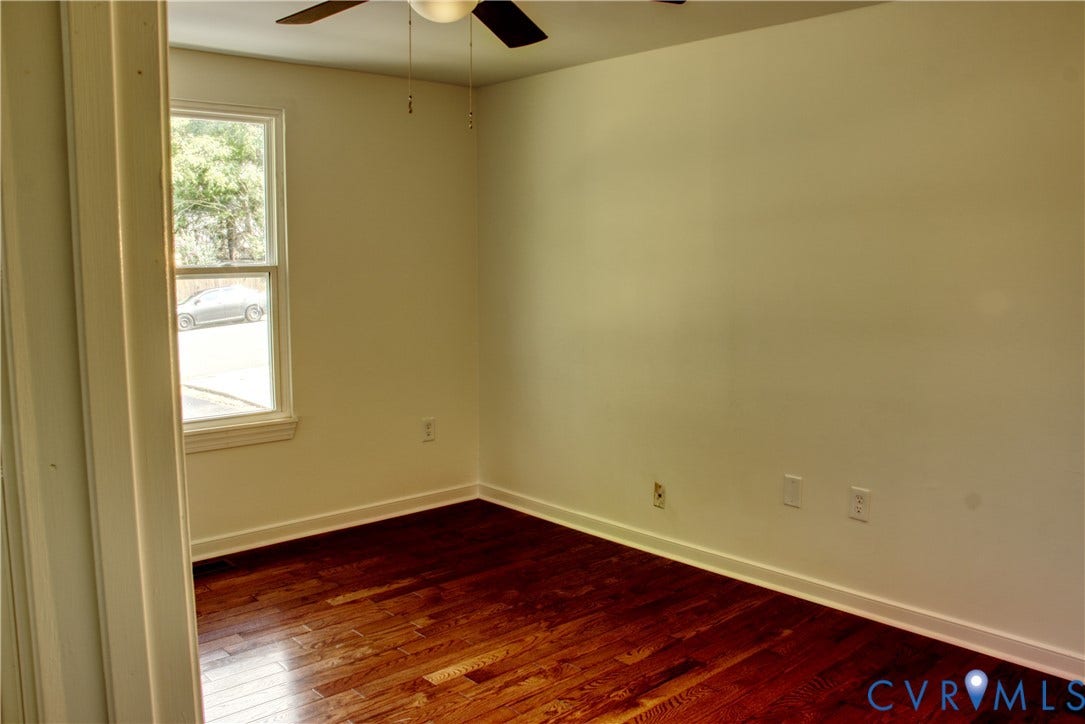 5004 Fairlake Lane, Henrico, VA 23060 Room featuring wood-finish flooring, white baseboards, a white-framed window, and a ceiling fan with integrated lighting