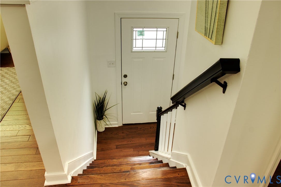 5004 Fairlake Lane, Henrico, VA 23060 Welcoming entryway featuring gleaming wood-finish flooring, white painted walls, and a black metal stair rail