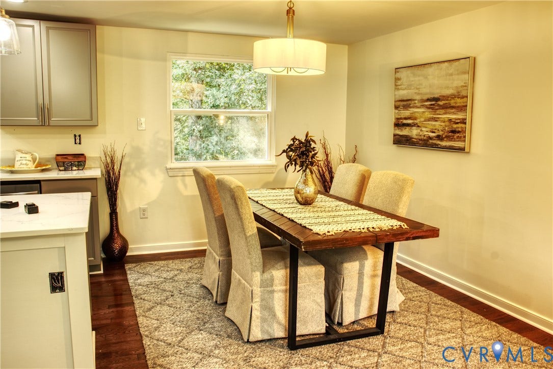 5004 Fairlake Lane, Henrico, VA 23060 Dining area featuring a wood-finish table, overhead drum pendant light, and a window providing natural light