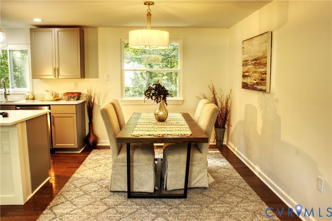 5004 Fairlake Lane, Henrico, VA 23060 Dining area featuring a contemporary chandelier, wood-finish flooring, and a large window