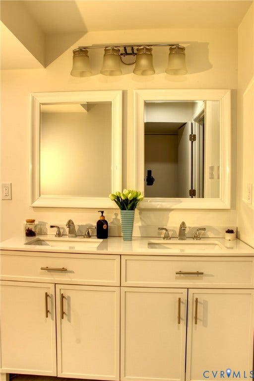 5004 Fairlake Lane, Henrico, VA 23060 Dual vanity featuring white cabinetry with gold-tone hardware, two integrated sinks, and a white countertop