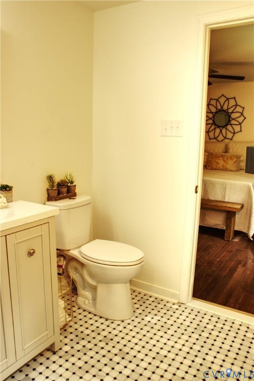 5004 Fairlake Lane, Henrico, VA 23060 Bathroom featuring white vanity with gold hardware, white countertop, white toilet, and black and white penny tile flooring