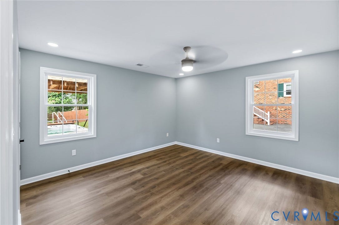 Wood-finish flooring, recessed lighting, and a ceiling fan with integrated light