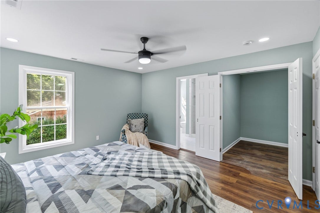 Spacious room featuring wood-finish flooring, a ceiling fan, recessed lighting, a window with grid panes, and a closet with bifold doors