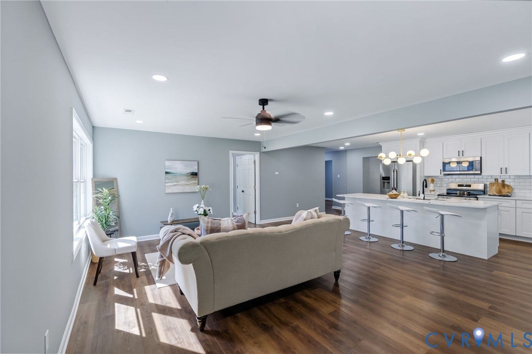 Open concept living space featuring wood-finish flooring, recessed lighting, and a ceiling fan