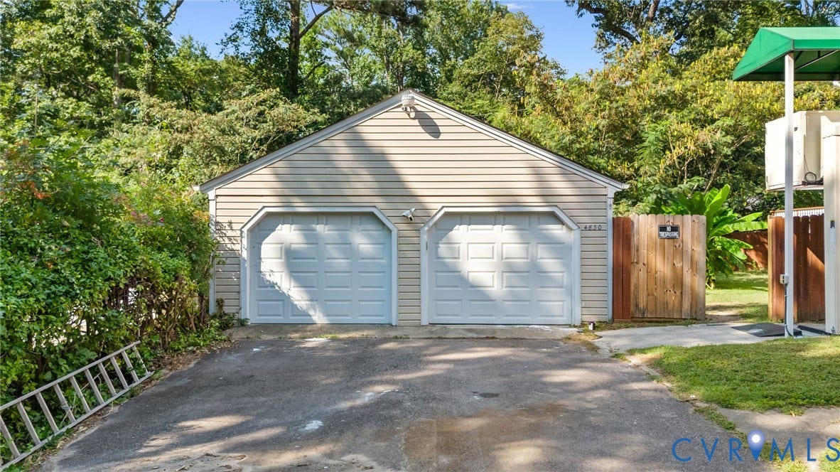 Two-car garage with horizontal siding and a gabled roofline