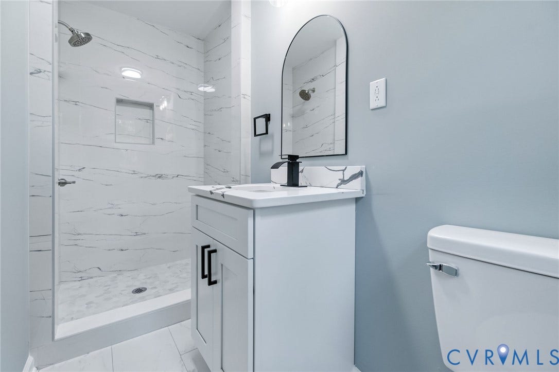 Glass-enclosed shower with a tiled surround