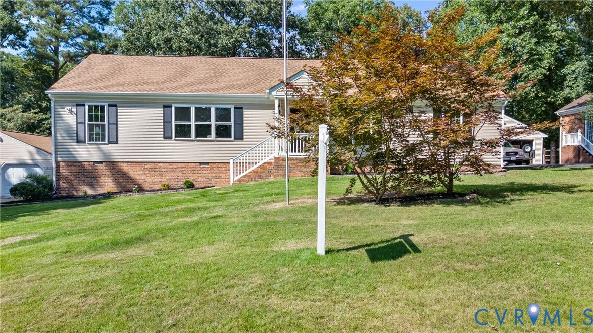 Siding exterior with brick foundation, shuttered windows, and a covered entry porch