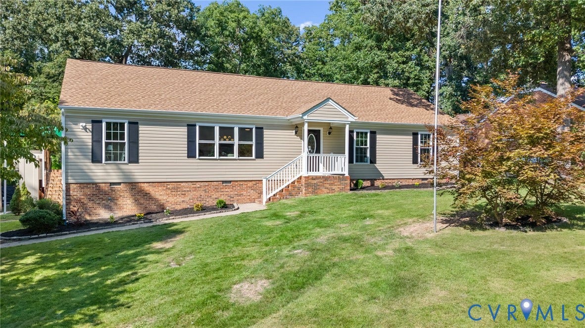 Ranch-style exterior with vinyl siding and a brick foundation