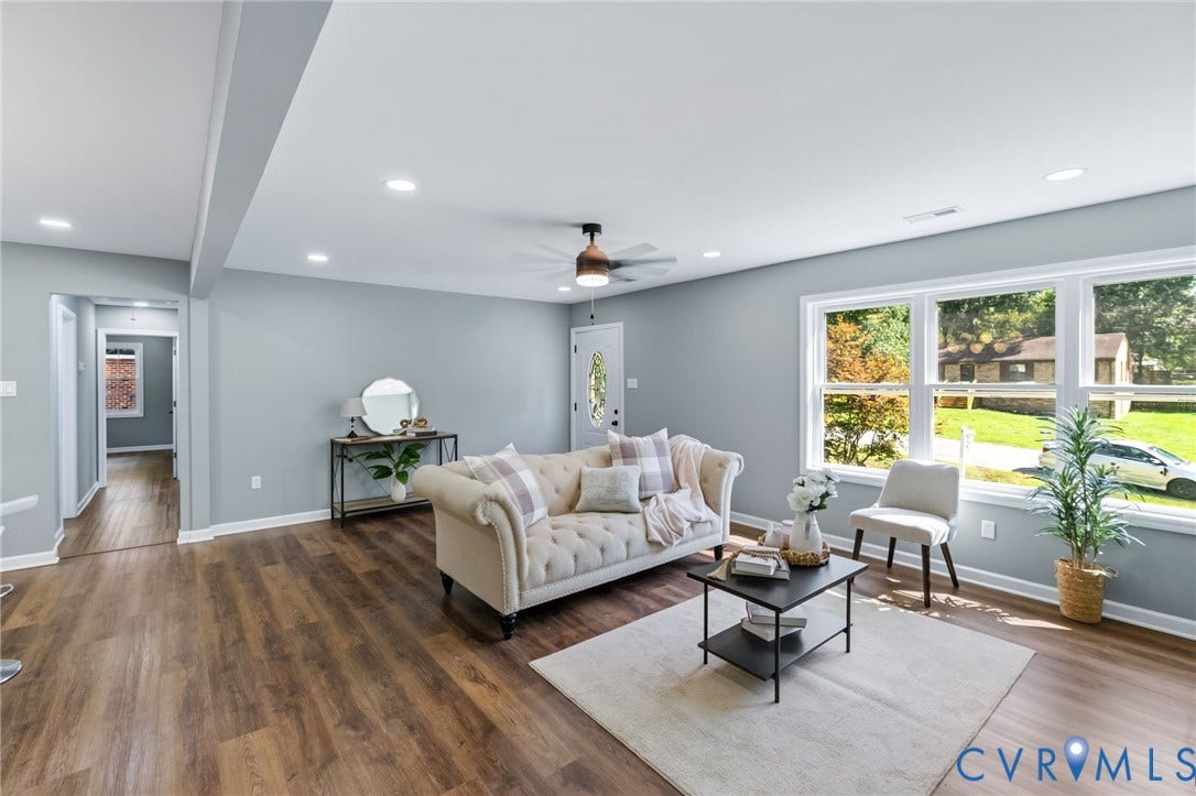 Spacious living area featuring wood-finish flooring, recessed lighting, and a ceiling fan