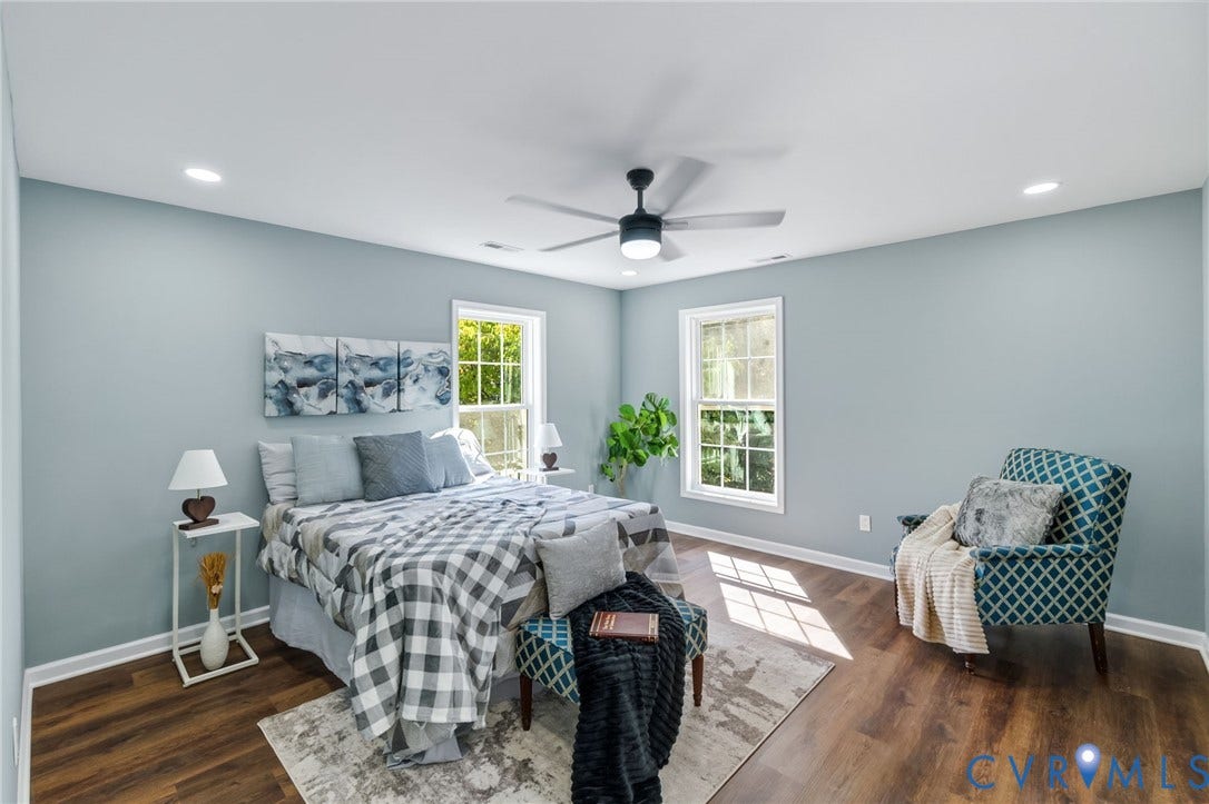 Recessed lighting, wood-finish flooring, two windows, and a ceiling fan with integrated lighting