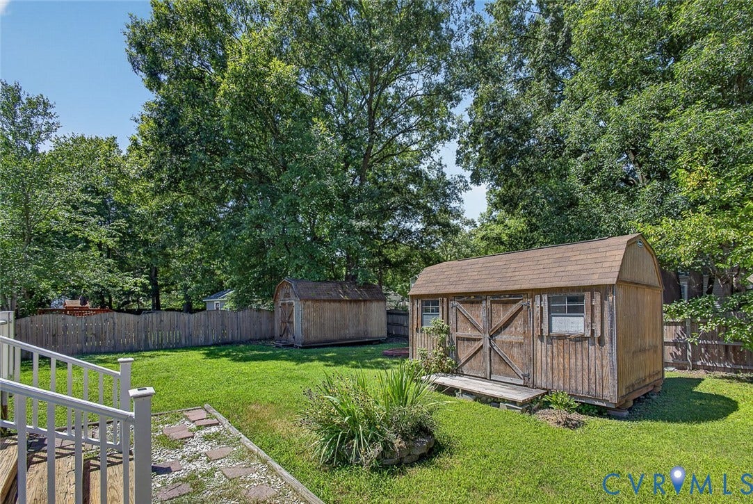 6302 Phobus Court, Richmond, VA 23234 Expansive green lawn featuring a large wooden storage shed with barn-style doors and shingle roof