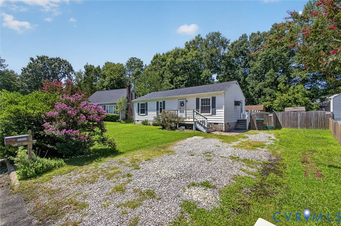 6302 Phobus Court, Richmond, VA 23234 White siding residence featuring a front deck with stairs, a gravel driveway, and a front yard with mature landscaping