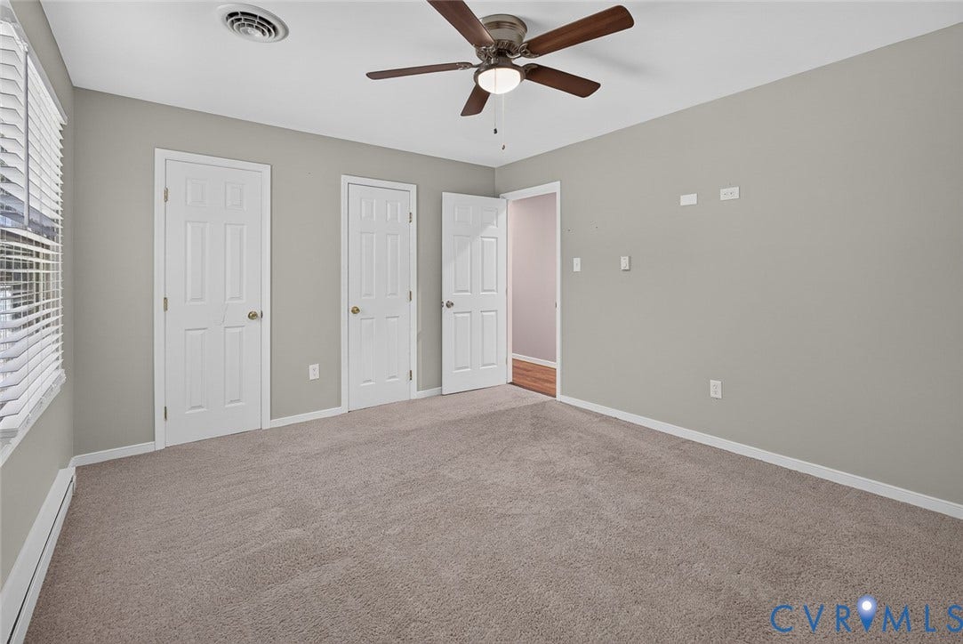 6302 Phobus Court, Richmond, VA 23234 Spacious interior room featuring light gray wall paint and a coordinating neutral carpet