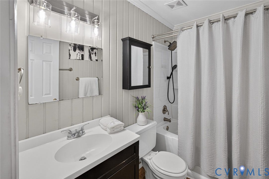 6302 Phobus Court, Richmond, VA 23234 Bathroom featuring a full vanity with an integrated sink, brushed nickel faucet, and a large wall mirror