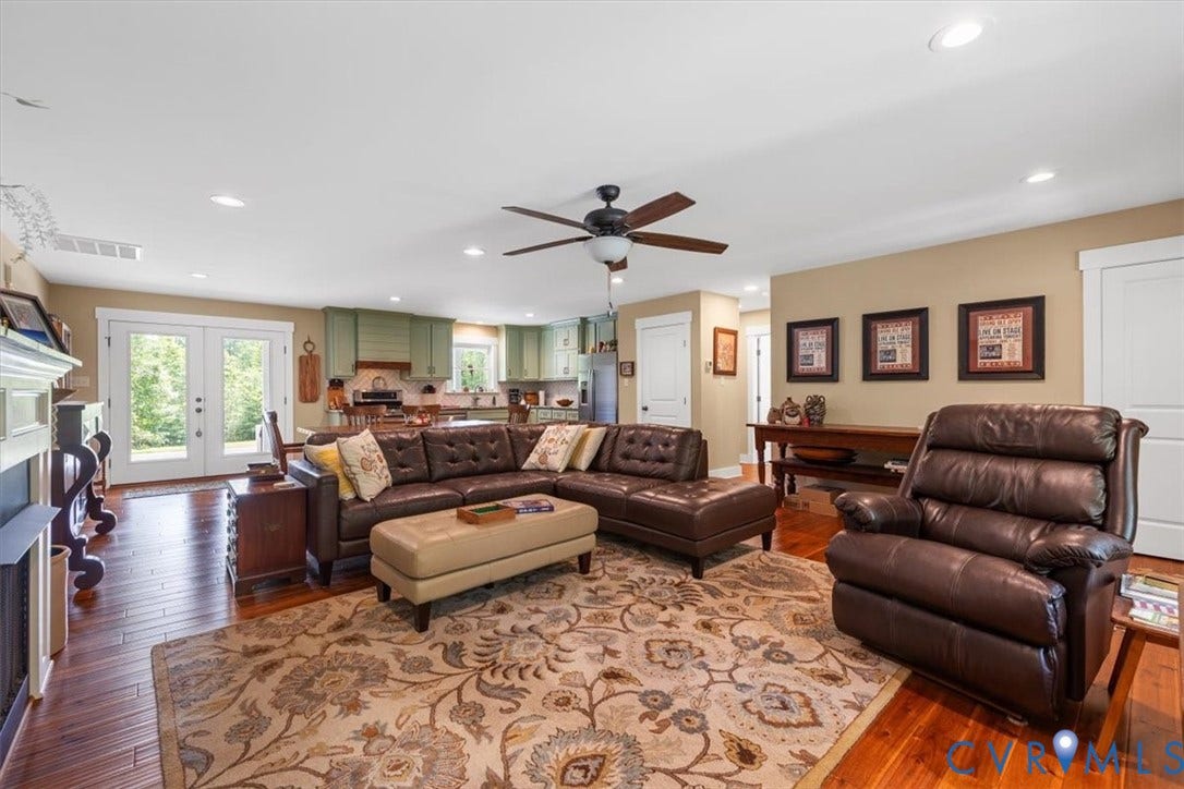 Expansive living area featuring hardwood flooring, recessed lighting, and a ceiling fan