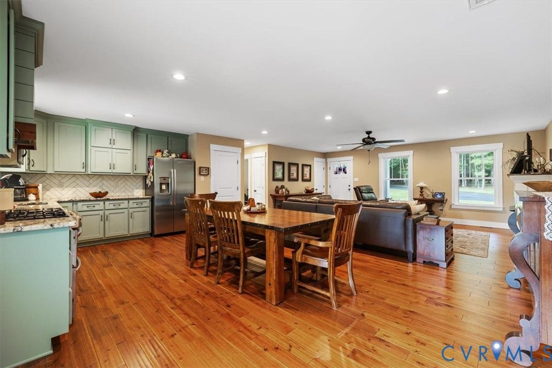 Open-concept living space featuring wood-finish flooring, recessed lighting, and a ceiling fan