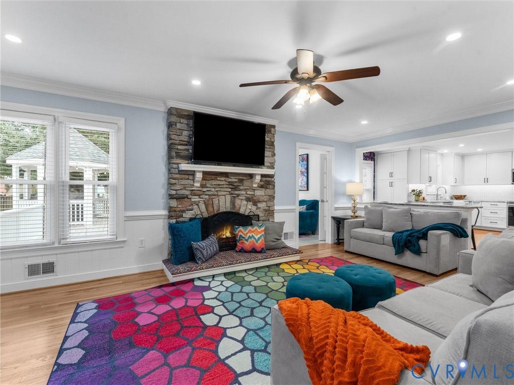 8216 Indian Springs Road, Richmond, VA 23237 Open-concept living space featuring a stone-clad fireplace with mantel, recessed lighting, and wood-finish flooring