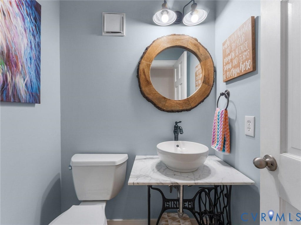 8216 Indian Springs Road, Richmond, VA 23237 Pedestal sink with white vessel basin and black faucet, set against a light blue wall