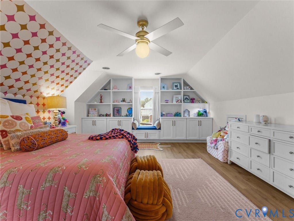 8216 Indian Springs Road, Richmond, VA 23237 Vaulted ceiling room featuring wood-finish flooring, a ceiling fan with integrated lighting, and a white built-in storage unit with open shelving and cabinet storage