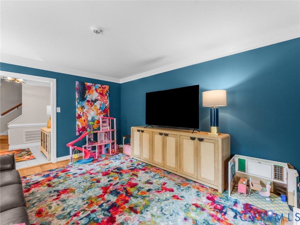 8216 Indian Springs Road, Richmond, VA 23237 Open living space featuring wood-finish flooring and crown molding