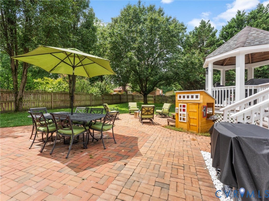 8216 Indian Springs Road, Richmond, VA 23237 Expansive brick paver patio featuring a white gazebo with a dark shingle roof and white railing