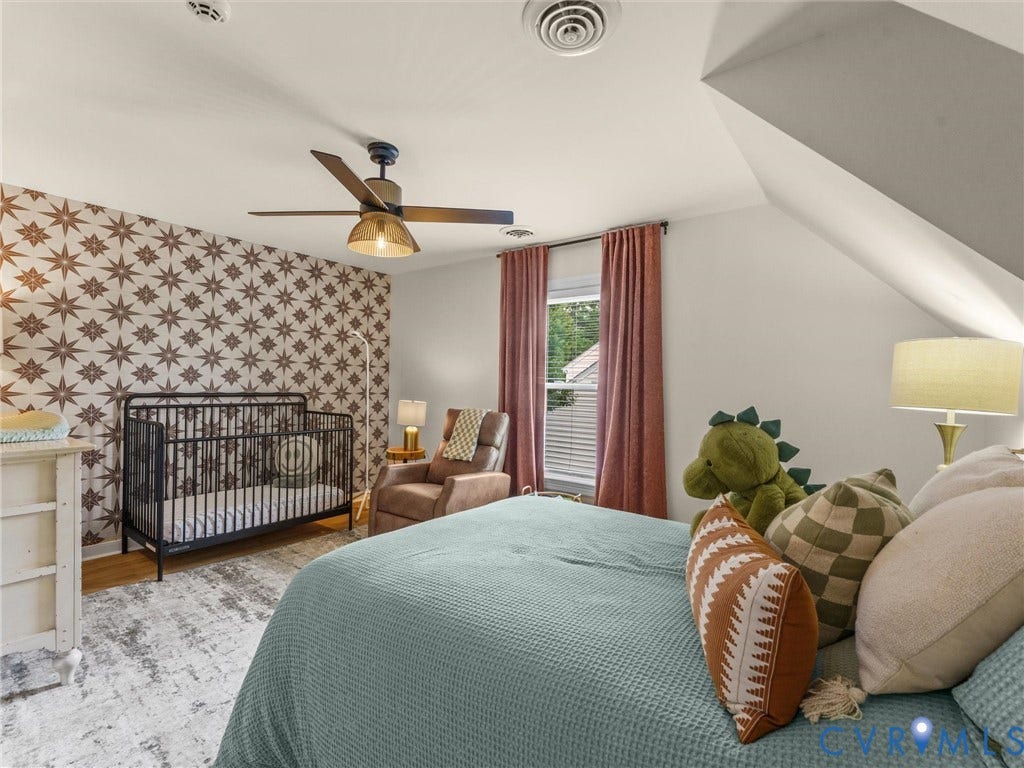 8216 Indian Springs Road, Richmond, VA 23237 Master bedroom suite featuring vaulted ceilings, ceiling fan with brass accents, and geometric patterned accent wall