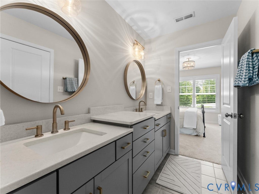 3647 Walkers Creek, Powhatan, VA 23139 Dual vanity with undermount sinks, light-toned countertops, and brass-finish fixtures