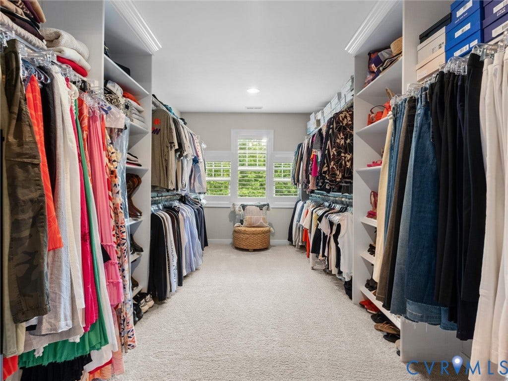 3647 Walkers Creek, Powhatan, VA 23139 Expansive walk-in closet featuring light-colored carpeting, built-in shelving, multiple hanging rods, and twin windows with plantation shutters