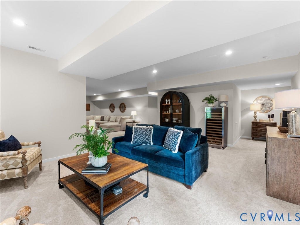 3647 Walkers Creek, Powhatan, VA 23139 Expansive lower-level recreational space featuring recessed lighting, carpet flooring, a built-in beverage refrigerator, and a built-in display cabinet