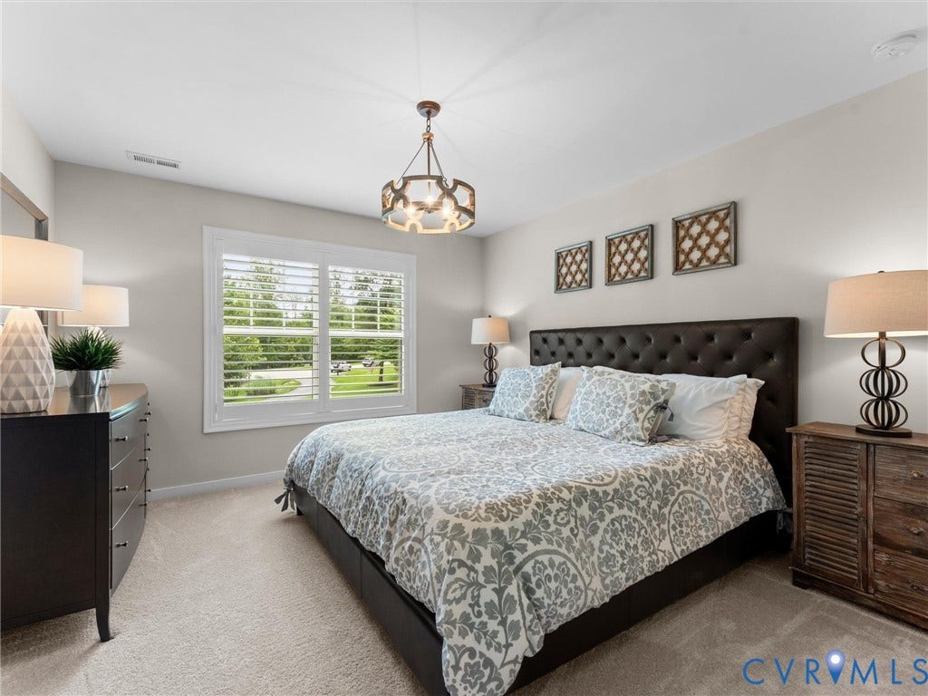 3647 Walkers Creek, Powhatan, VA 23139 Window with plantation shutters, soft carpet flooring, sloped ceiling, and an ornate ceiling light fixture