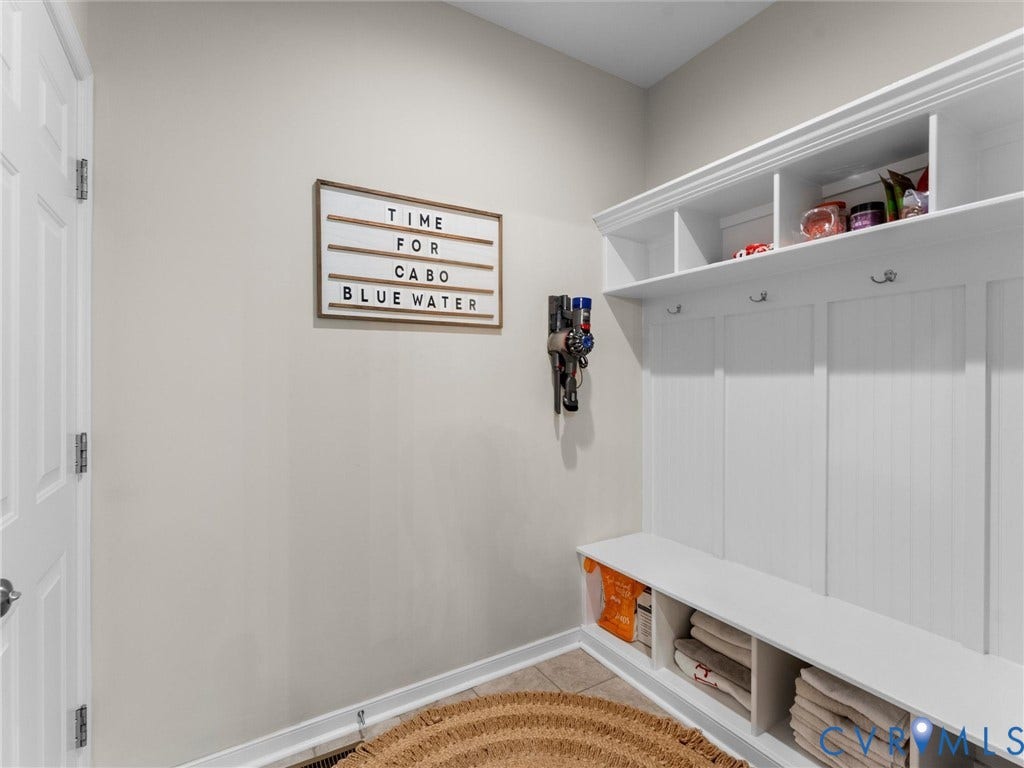 3647 Walkers Creek, Powhatan, VA 23139 Built-in white storage bench with open shelving, wall hooks, and beadboard paneling