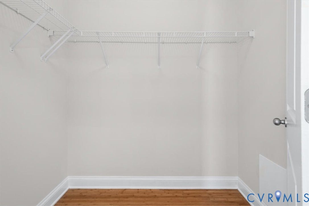 1333 Broad Street, #510, Ironhouse Place Condominiums, Richmond, VA 23220 Functional closet space featuring wire shelving, white baseboards, and wood-finish flooring