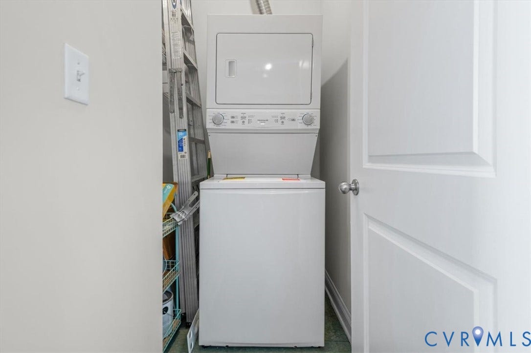 1333 Broad Street, #510, Ironhouse Place Condominiums, Richmond, VA 23220 Dedicated laundry area featuring a white stacked washer and dryer unit