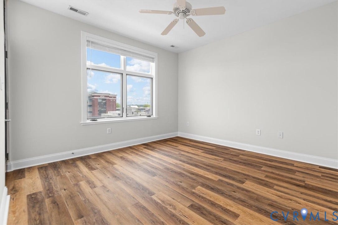1333 Broad Street, #510, Ironhouse Place Condominiums, Richmond, VA 23220 Spacious room featuring wood-finish flooring and a large window with white trim