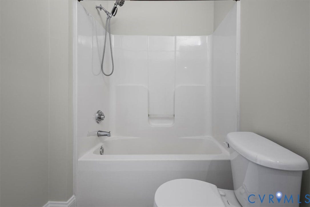 1333 Broad Street, #510, Ironhouse Place Condominiums, Richmond, VA 23220 White bathtub and shower combination unit featuring a chrome showerhead and faucet