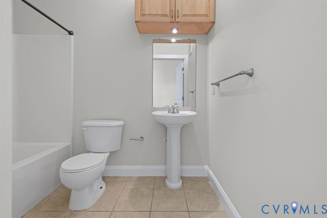 1333 Broad Street, #510, Ironhouse Place Condominiums, Richmond, VA 23220 Bathroom featuring a pedestal sink, wall-mounted mirror, and wood-finish cabinetry with recessed lighting