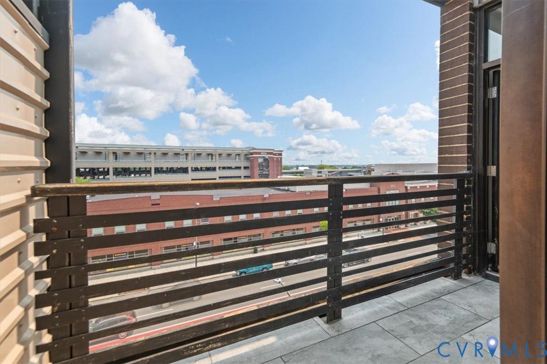 1333 Broad Street, #510, Ironhouse Place Condominiums, Richmond, VA 23220 Private balcony featuring horizontal metal railings, concrete-style flooring, and a composite siding exterior