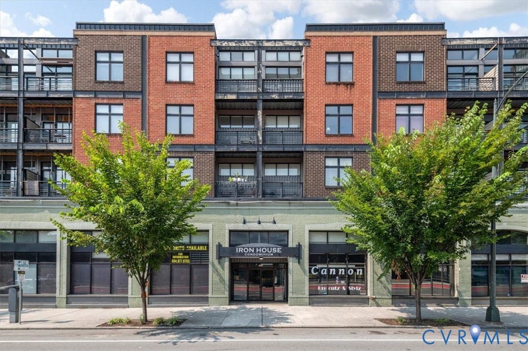1333 Broad Street, #510, Ironhouse Place Condominiums, Richmond, VA 23220 Multi-story building featuring a brick upper facade with metal accents and a light green commercial-style base