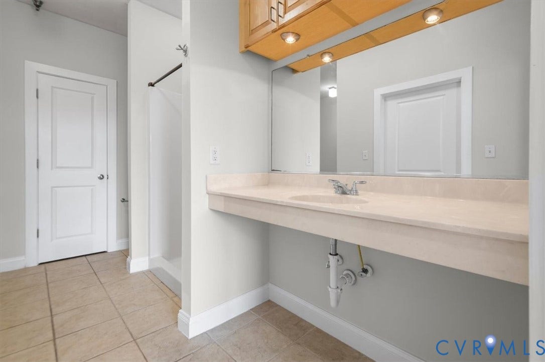 1333 Broad Street, #510, Ironhouse Place Condominiums, Richmond, VA 23220 Bathroom featuring a light-colored vanity with an integrated sink, a rectangular mirror, and overhead lighting