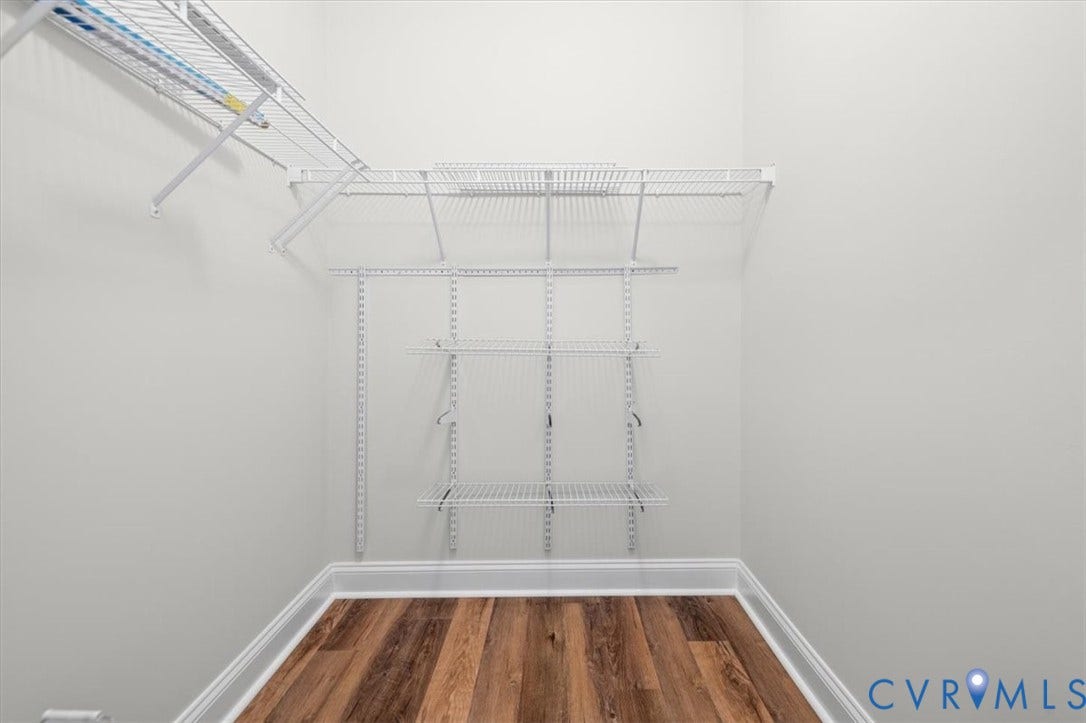1333 Broad Street, #510, Ironhouse Place Condominiums, Richmond, VA 23220 Walk-in closet featuring wire shelving, wire hanging rods, light gray walls, white baseboards, and wood-finish flooring